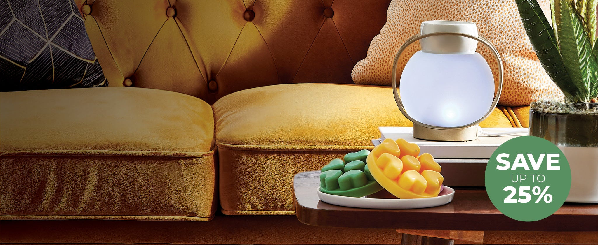 Yellow sofa with a small table holding a plate of melts and a decorative melt warmer, with a 'Save 25%' label in the corner.