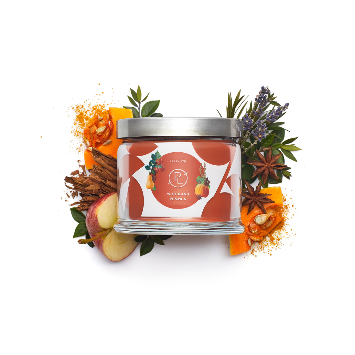 Woodland Pumpkin 3-wick jar candle with sliced fruit and leaves against a white background.