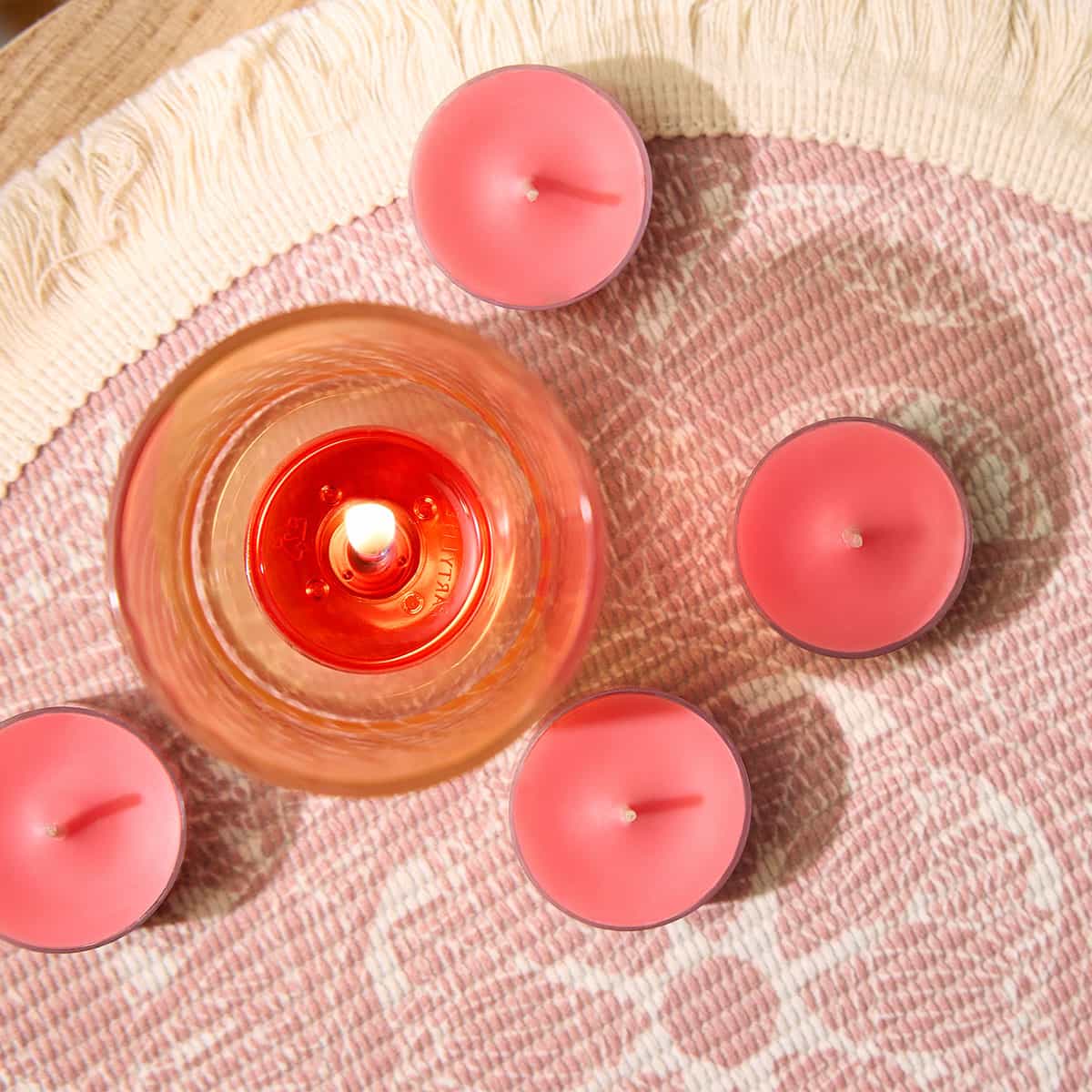 Beachside Tiare Tealights shown with a tealight holder on a decorative woven table mat